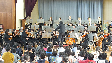 Children attentively listen to the live performance